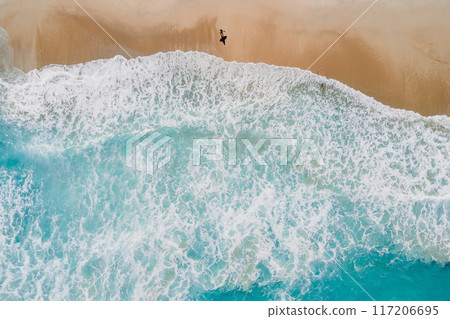Surfer walk on beach and blue ocean with waves. Aerial view 117206695