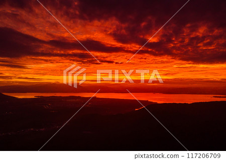 Sunrise or sunset with clouds and silhouette of coastline in Florianopolis, Brazil 117206709