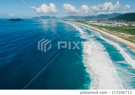 Beach coastline and ocean with waves on sunny day in Brazil. Aerial view of Morro das Pedras, Florianopolis 117206713