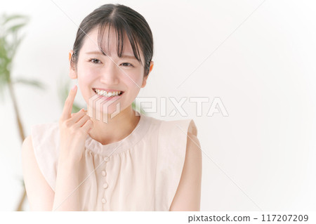 一個 20 多歲的女人摸著臉頰 一個 20 多歲的女人摸著臉頰 117207209