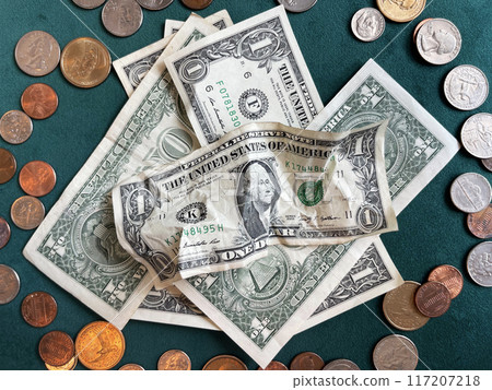 USA coins and banknotes scattered on the table 117207218