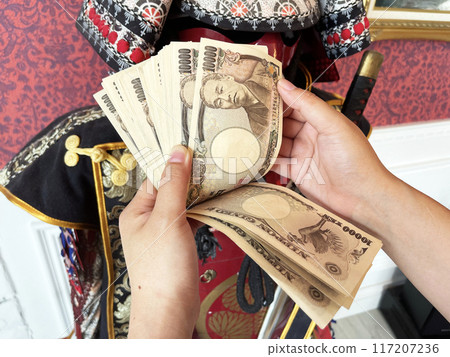 japanese stack of money in hand count 117207236