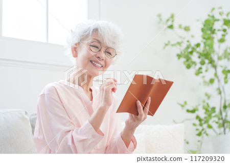 在筆記本上做筆記的高級女性 在筆記本上做筆記的高級女性 117209320