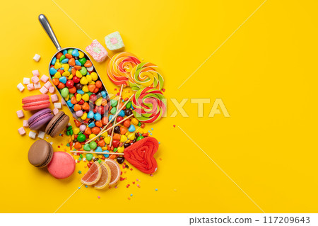 Various colorful candies, lollipops, and macaroons 117209643
