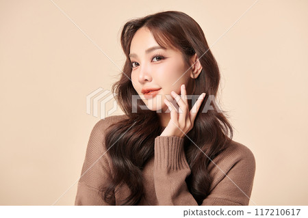 Beautiful young asian woman with clean fresh skin on beige background, Face care, Facial treatment, Cosmetology, beauty and spa, Asian women portrait. 117210617