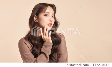 Beautiful young asian woman with clean fresh skin on beige background, Face care, Facial treatment, Cosmetology, beauty and spa, Asian women portrait. 117210618