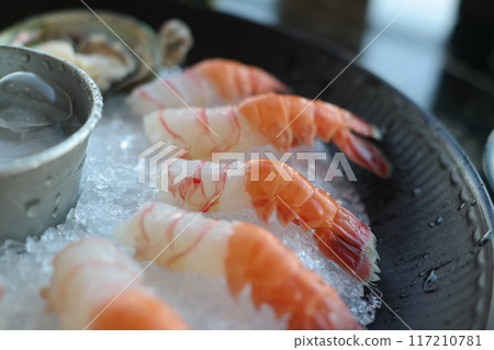 Raw fresh shrimps on ice in a restaurant 117210781