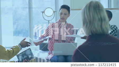 Image of financial data processing over diverse business people in office Image of financial data processing over diverse business people in office 117211415