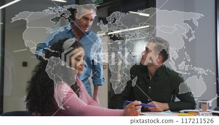 World map image over diverse business team discussing project in office 117211526