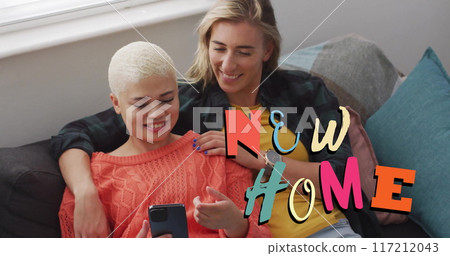 Image of new home text over gay lesbian couple using smartphone at home Image of new home text over gay lesbian couple using smartphone at home 117212043
