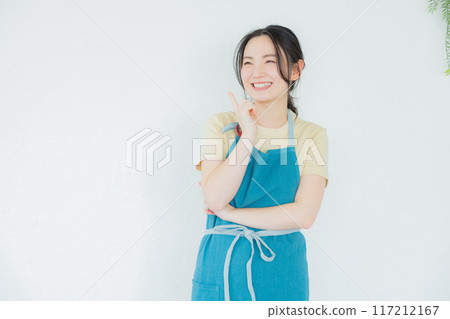 A woman in an apron thinking A woman in an apron thinking 117212167