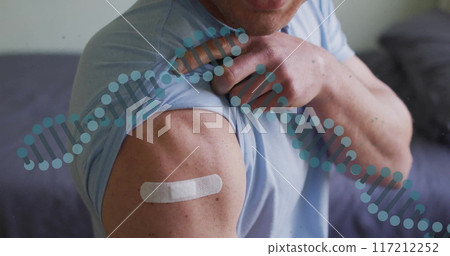 DNA strand image over person showing arm with bandage DNA strand image over person showing arm with bandage 117212252