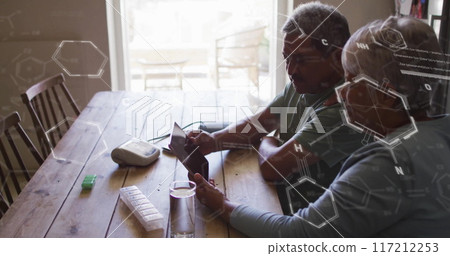 Chemical structure image over elderly couple using tablet at wooden table Chemical structure image over elderly couple using tablet at wooden table 117212253