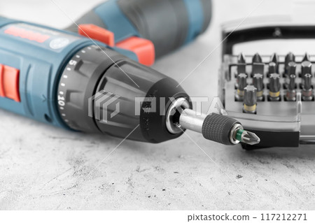 Professional cordless drill screwdriver and screwdriver bit set close-up Professional cordless drill screwdriver and screwdriver bit set close-up 117212271