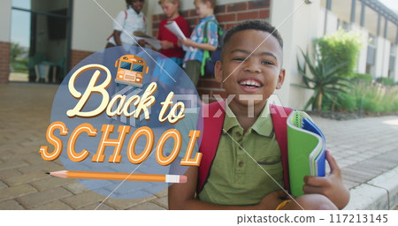 Image of back to school text over happy biracial schoolboy at school 117213145