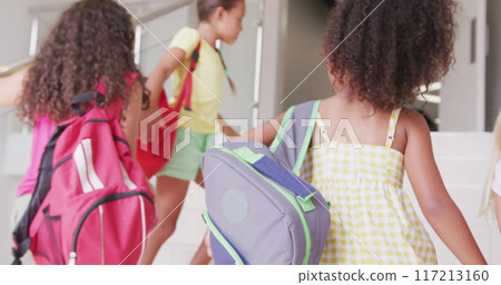 Image of balloons and back to school text over happy diverse school kids at school 117213160