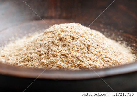 Medicinal isabgol or psyllium husks in brown wooden bowl close up 117213739