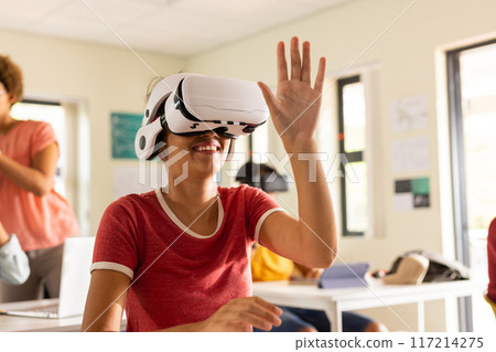 In high school, teenager using VR headset and interacting with virtual environment 117214275