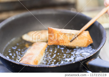 Spring rolls fried in a frying pan 117215119