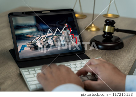 Businessman engaged in gavel stock market investment law, tablet, and forex analysis 117215138