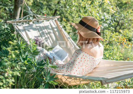 Young woman relaxing in a hammock 117215973