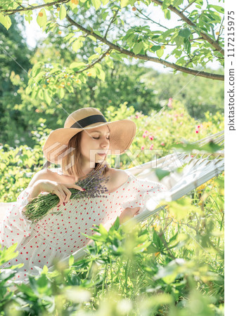 Young woman relaxing in a hammock 117215975