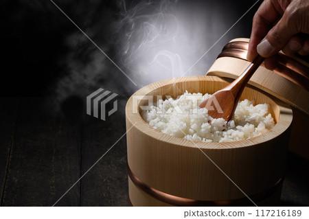 Freshly cooked hot steaming rice in a rice cooker (black background) Freshly cooked hot steaming rice in a rice cooker (black background) 117216189