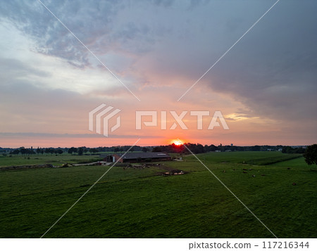 A Stunning Sunset Gracing the Serene Farmland Landscape, Capturing Natures Beauty at Dusk 117216344