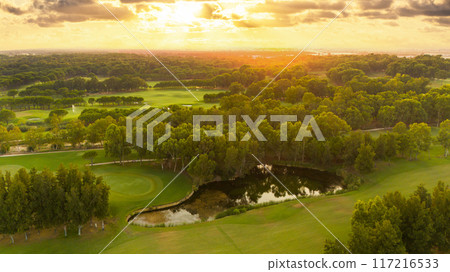 Aerial panoramic view of golf course during sunset Aerial panoramic view of golf course during sunset 117216533