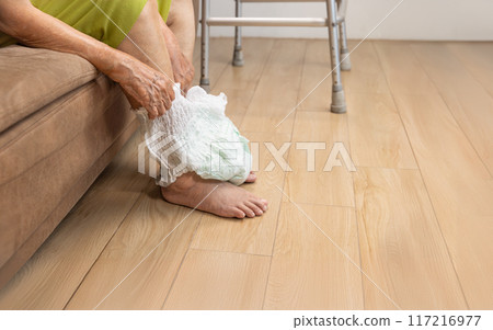 Urinary Incontinence in elderly and changing diaper. Urinary Incontinence in elderly and changing diaper. 117216977