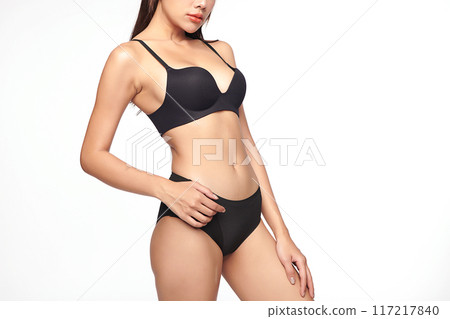 Confident beautiful young asian woman posing in black lingerie on white background, Perfect body, 117217840