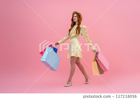 Cute fashionista with many shopping bags looking excited 117218056