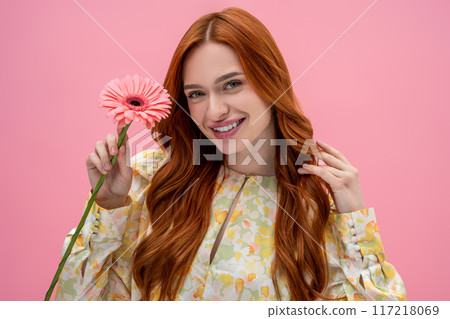 Long-haired caucasian young woman smiling and looking happy and relaxed 117218069