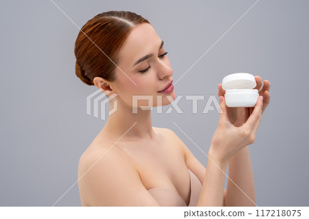 Young woman holding a jar of cream in hands Young woman holding a jar of cream in hands 117218075