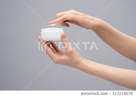 Close up of females hands with a jar of face cream 117218076