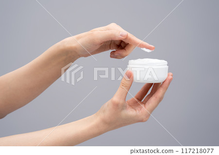 Close up of females hands with a jar of face cream 117218077