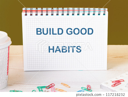Business, psychological build good habits concept. Concept words Build good habits in a checkered notebook on the table 117218232
