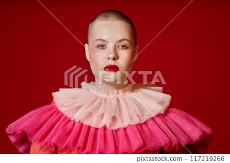 Minimal front view portrait of young woman with buzzcut wearing ruffle dress on red background copy space Minimal front view portrait of young woman with buzzcut wearing ruffle dress on red background copy space 117219266