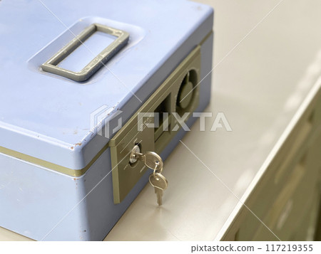 A light blue safe on a steel desk A light blue safe on a steel desk 117219355