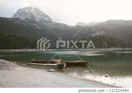 View of the Black Lake or Crno jezero , northern Montenegro. Tourist boats near wooden pier on Black lake in Durmitor national park near Zabljak, Europe 117220364