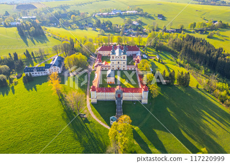 Hora Matky Bozi Monastery in Dolni Hedec near Kraliky, Czechia. It shows the monastery complex with its surrounding greenery and nearby village. 117220999