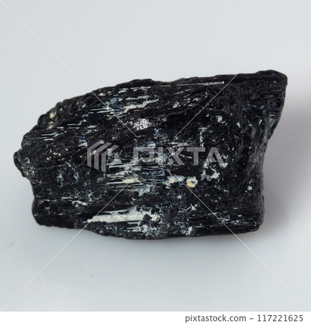 natural black tourmaline scherl on the white background natural black tourmaline scherl on the white background 117221625
