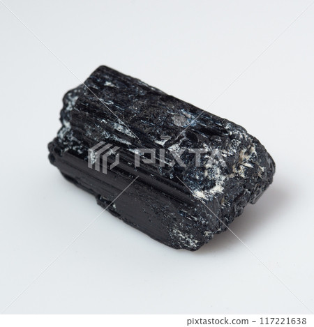 natural black tourmaline scherl on the white background natural black tourmaline scherl on the white background 117221638