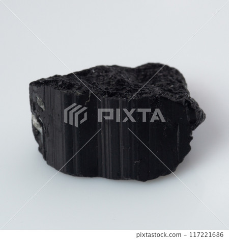 natural black tourmaline scherl on the white background natural black tourmaline scherl on the white background 117221686