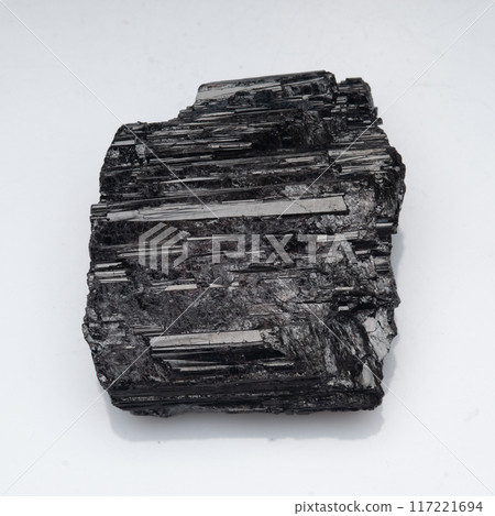 natural black tourmaline scherl on the white background natural black tourmaline scherl on the white background 117221694