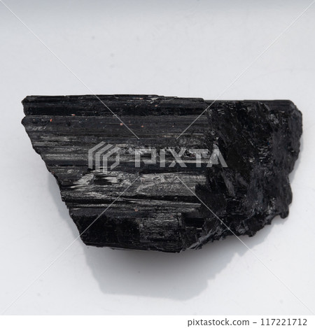 natural black tourmaline scherl on the white background natural black tourmaline scherl on the white background 117221712