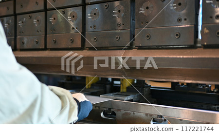 An operator bending steel materials with a bender (steel material set) Factory Ironworks 117221744