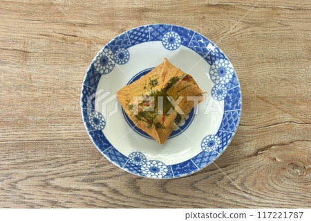 steamed chop clown knife fish with curry dressing coconut milk and topping slice lemon grass leaf on plate steamed chop clown knife fish with curry dressing coconut milk and topping slice lemon grass leaf on plate 117221787