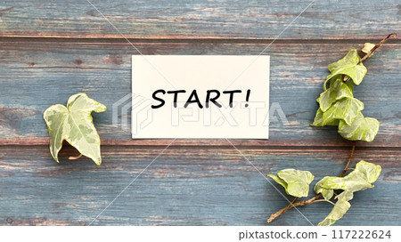 A white card placed horizontally with the words START! written on it_Blue board background_Wide A white card placed horizontally with the words START! written on it_Blue board background_Wide 117222624