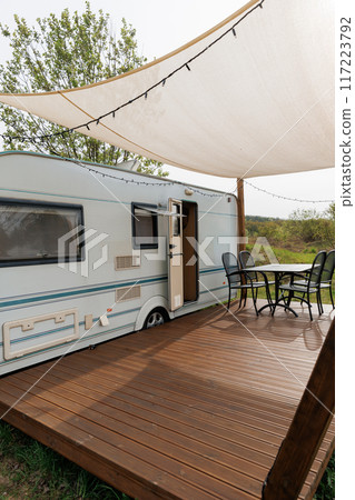 Caravan or camper trailer with Wooden Deck at Countryside Glamping Site. Outdoor Camping 117223792